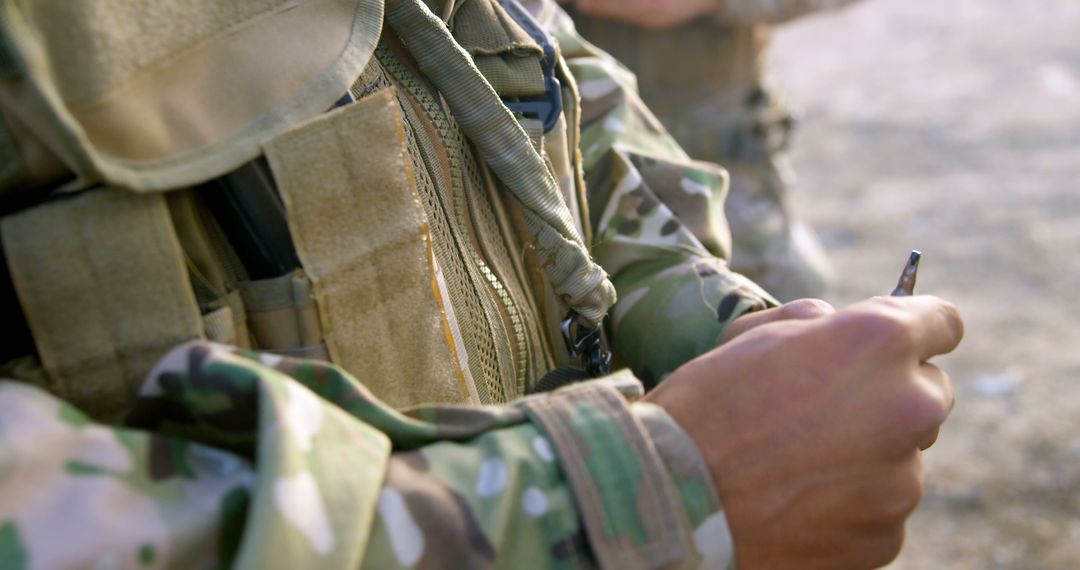 Soldier in Camouflage Military Uniform Holding Knife - Free Images, Stock Photos and Pictures on Pikwizard.com