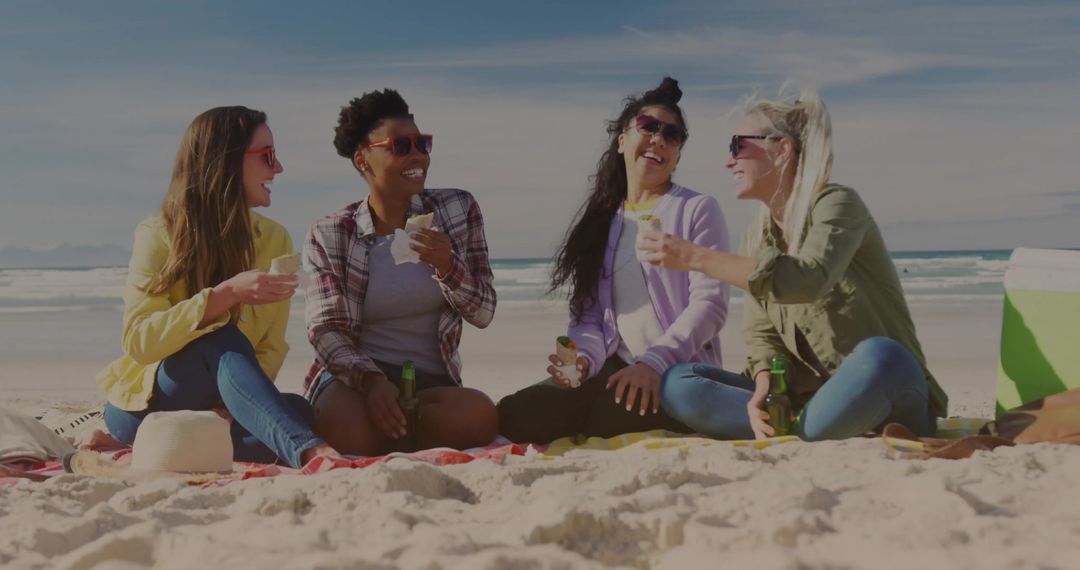 Group of Friends Enjoying Day at Beach with Snacks and Drinks