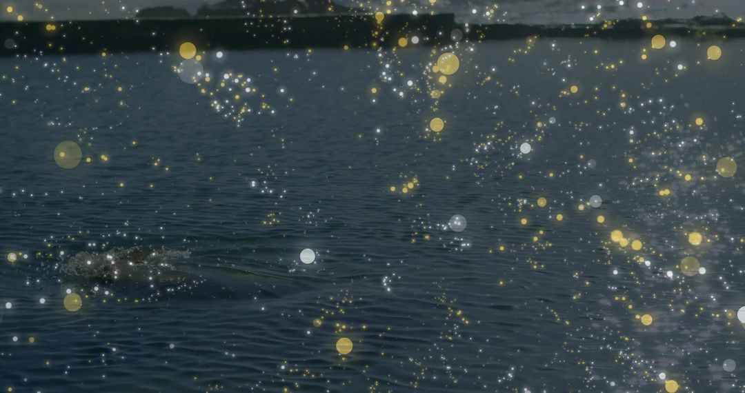Tranquil Water Surface with Golden Sparkles at Dusk