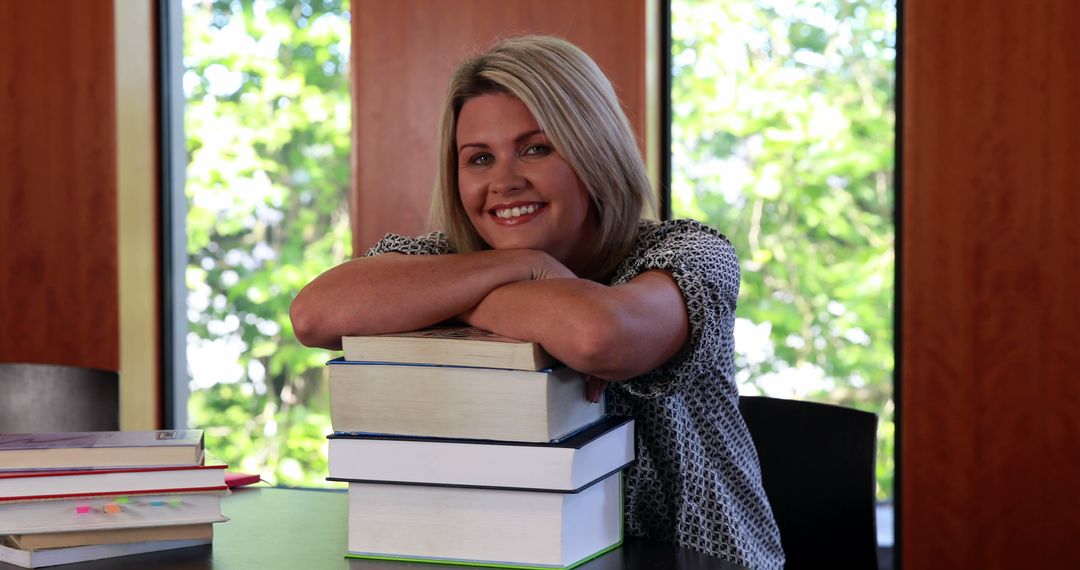 Smiling Student with Stack of Books in Library - Free Images, Stock Photos and Pictures on Pikwizard.com