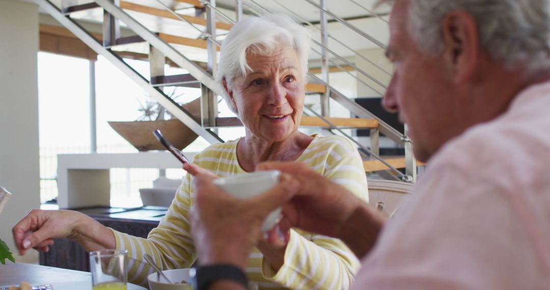 Senior Couple Enjoying Breakfast and Conversation at Home