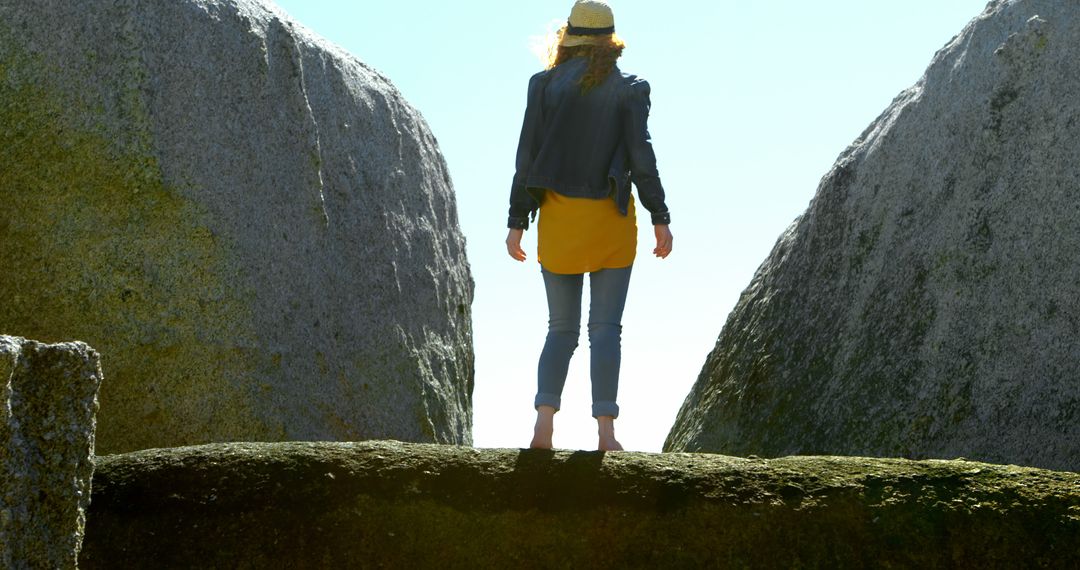 Woman Standing on Rock Bridge Between Huge Boulders Outdoors - Free Images, Stock Photos and Pictures on Pikwizard.com