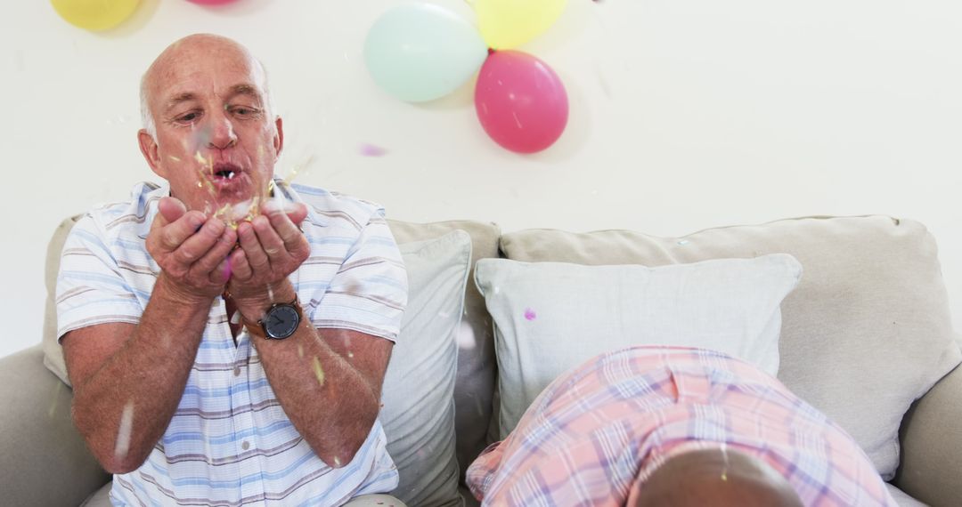 Senior Friends Enjoying Party with Balloons and Confetti Indoors