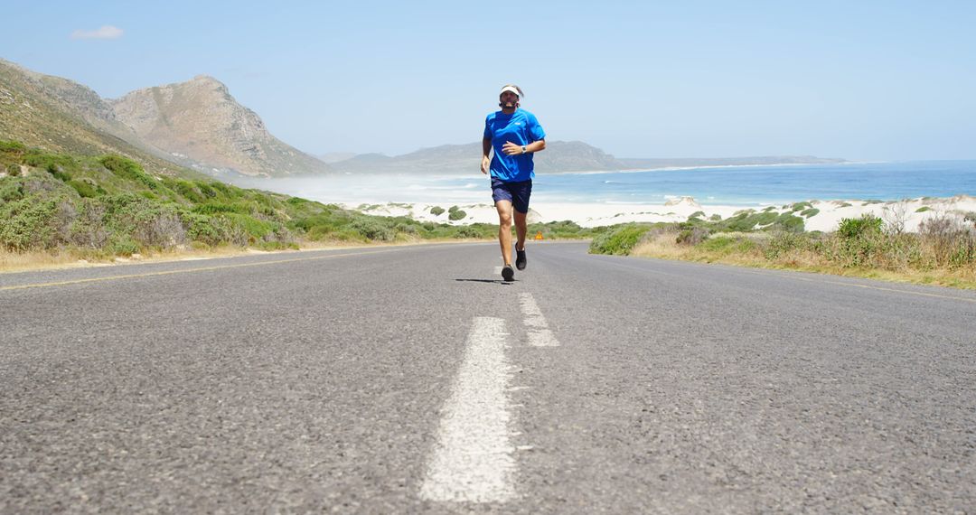 Man Running on Coastal Road - Free Images, Stock Photos and Pictures on Pikwizard.com