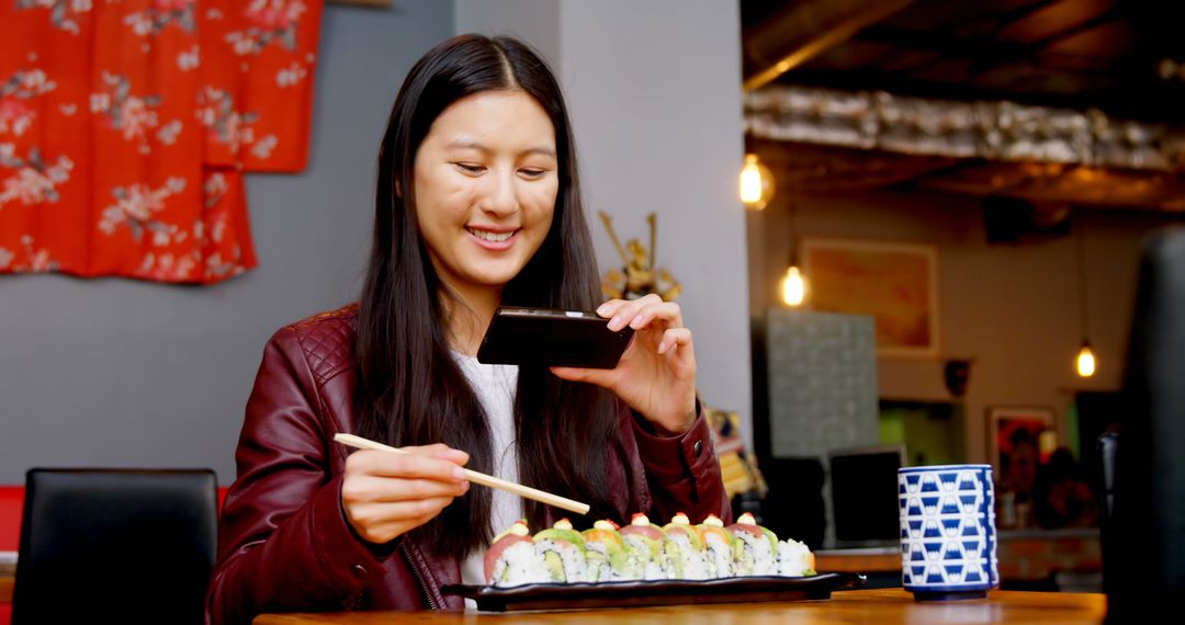 Woman Photographing Sushi with Smartphone in Restaurant - Free Images, Stock Photos and Pictures on Pikwizard.com