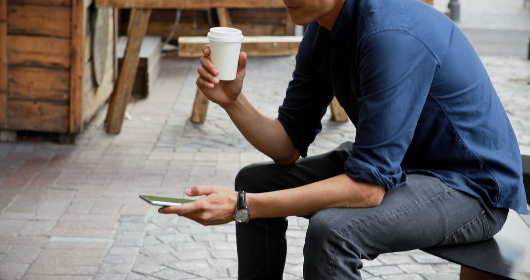 Man Drinking Coffee Sitting Outdoors at Urban Cafe - Free Images, Stock Photos and Pictures on Pikwizard.com