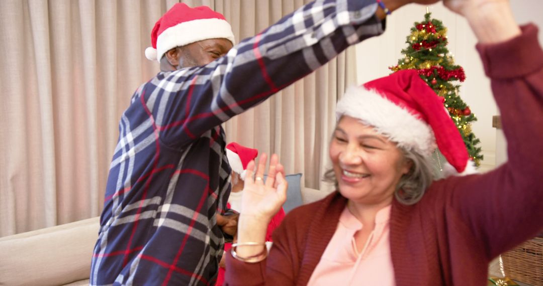 Happy Elderly Couple Dancing During Christmas at Home - Free Images, Stock Photos and Pictures on Pikwizard.com