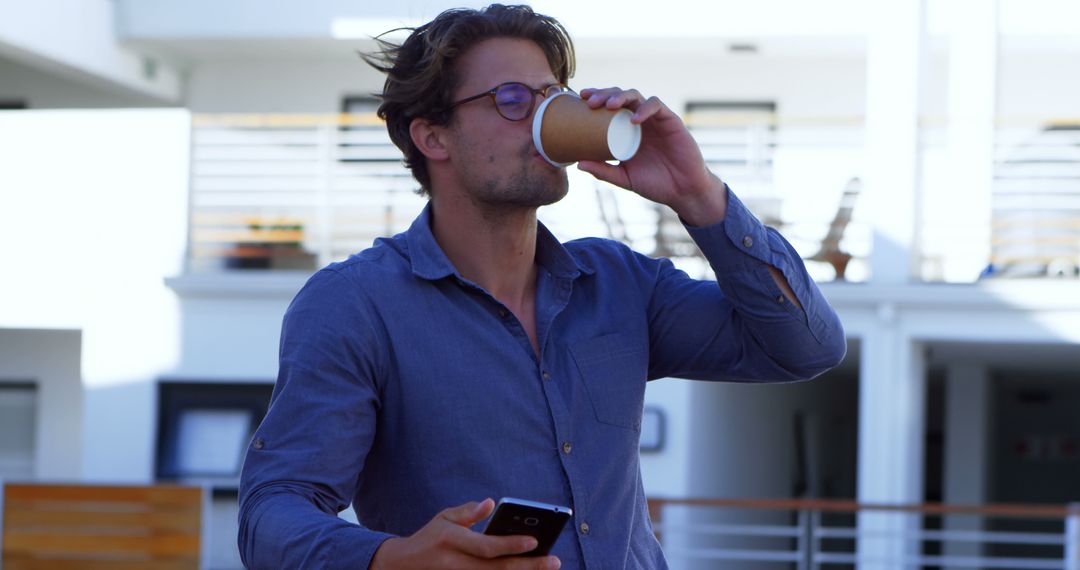 Businessman Drinking Coffee and Checking Phone - Free Images, Stock Photos and Pictures on Pikwizard.com