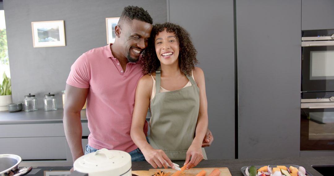Smiling Couple Enjoying Cooking Together at Home