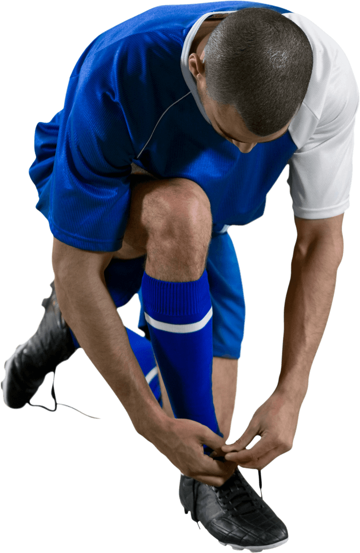 Football Player Tying Shoelaces in Blue and White Kit Transparent Background