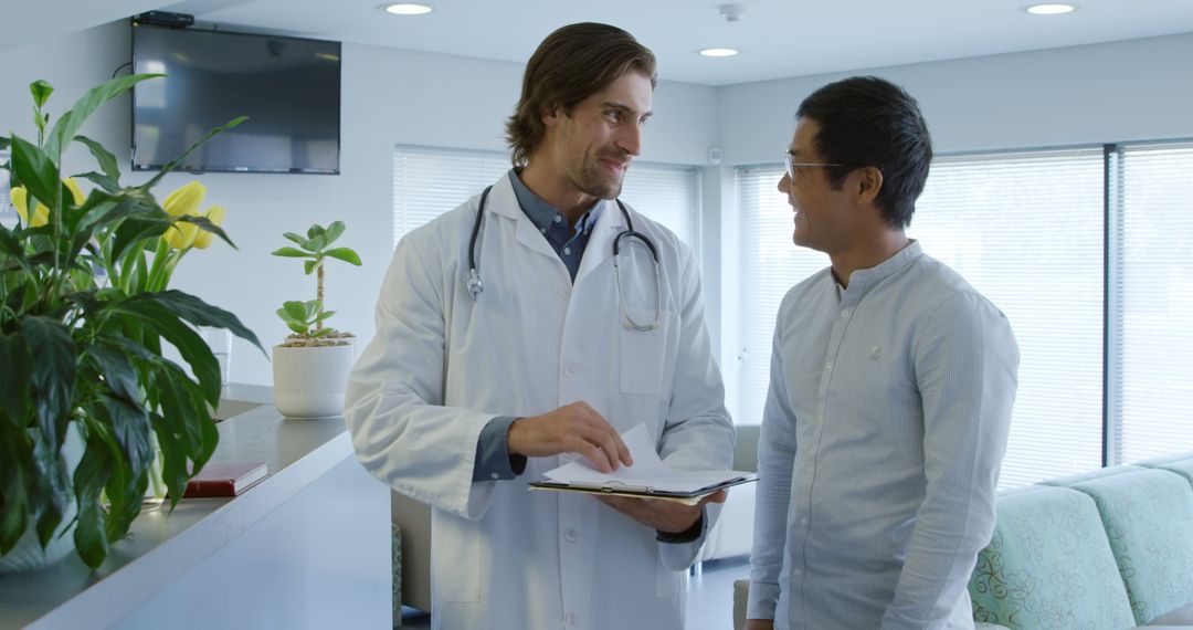 Doctor Discussing Medical Results with Smiling Patient at Clinic - Free Images, Stock Photos and Pictures on Pikwizard.com