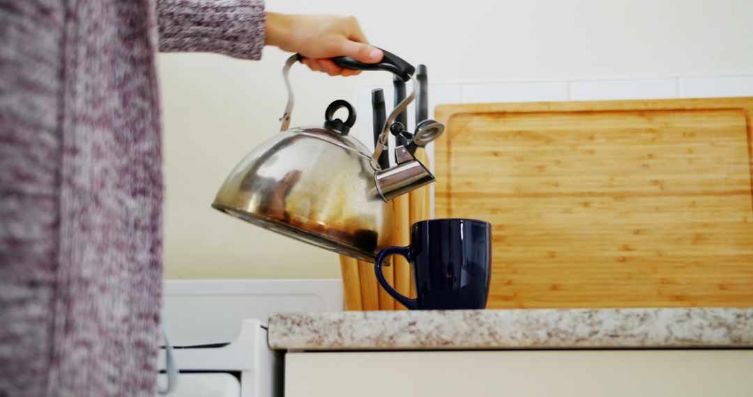 Close-up of Person Pouring Hot Water Into Mug on Kitchen Counter - Free Images, Stock Photos and Pictures on Pikwizard.com