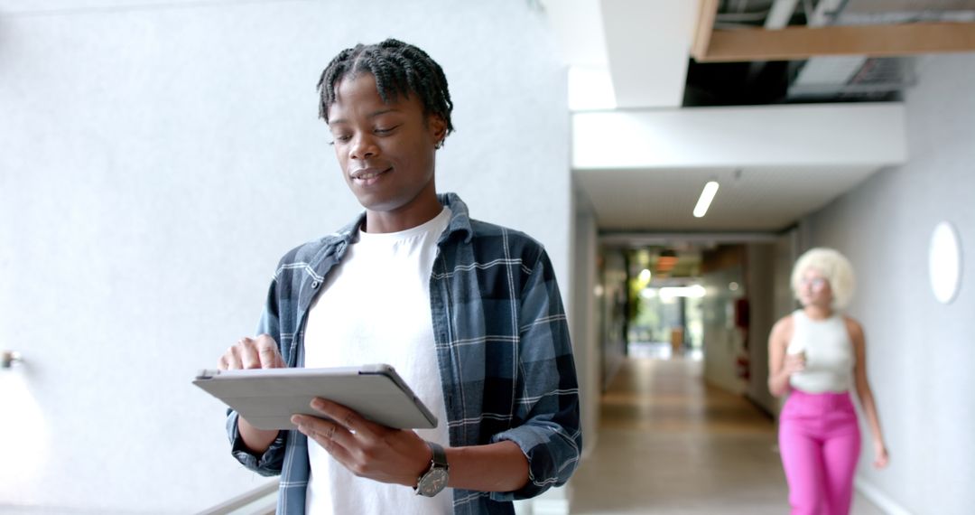 Focused Professional Using Digital Tablet in Modern Office Environment