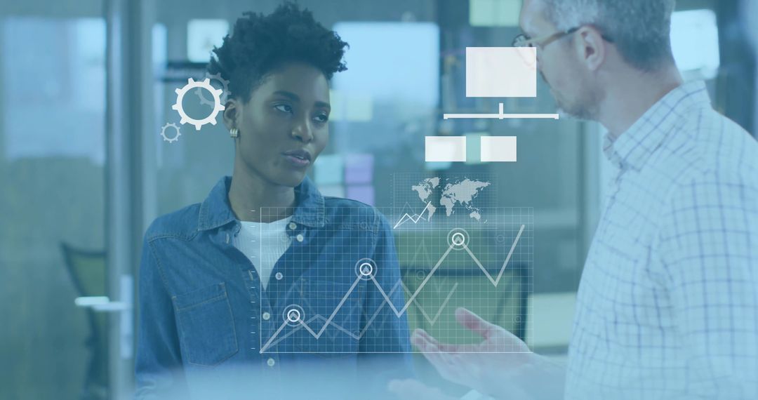 Business colleagues discussing analytics dashboard on glass partition with data overlay