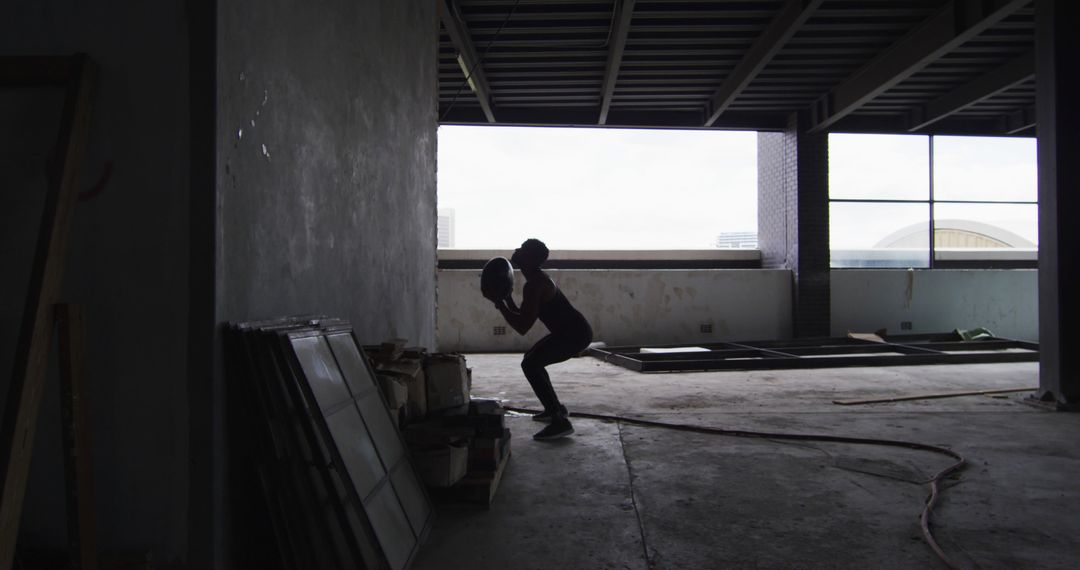 Silhouette of Construction Worker Installing Drywall in Building Under Renovation - Free Images, Stock Photos and Pictures on Pikwizard.com