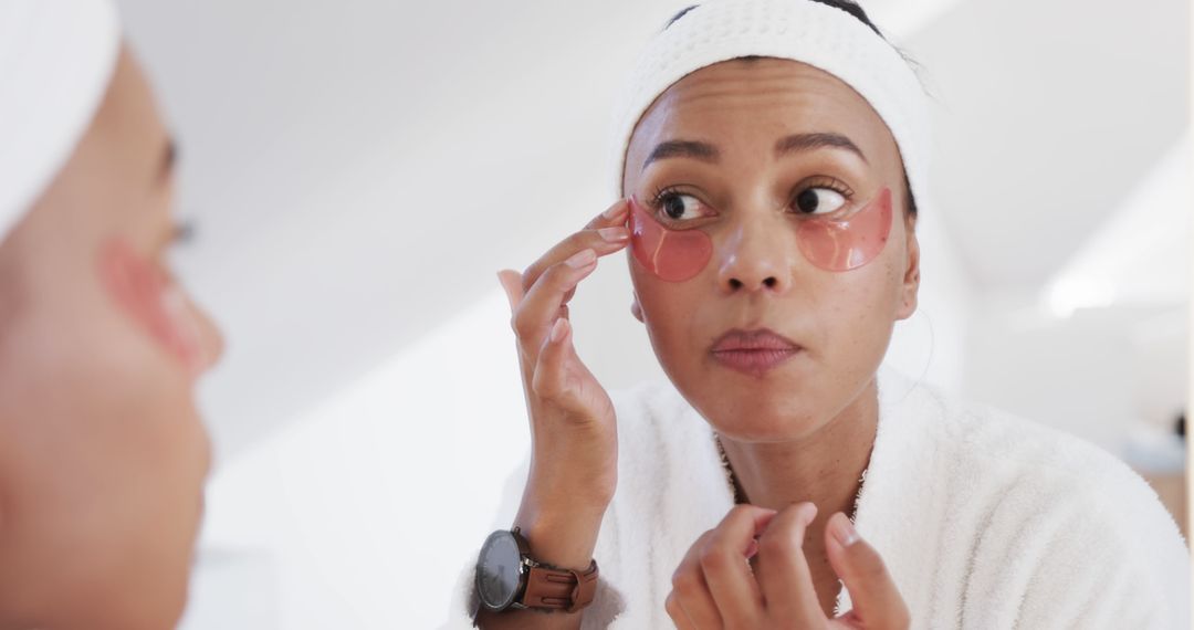 Woman Applying Under Eye Patches for Skincare Routine in Bathroom - Free Images, Stock Photos and Pictures on Pikwizard.com