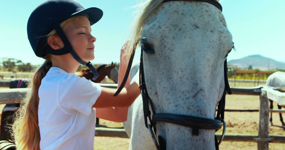 A girl in a helmet displays a close bond with her horse, hinting at mutual trust. - Free Images, Stock Photos and Pictures on Pikwizard.com