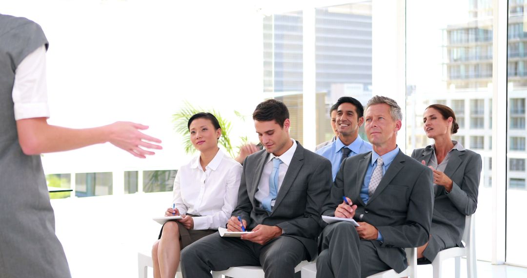 Diverse Professionals Engaged in Business Seminar Discussion
