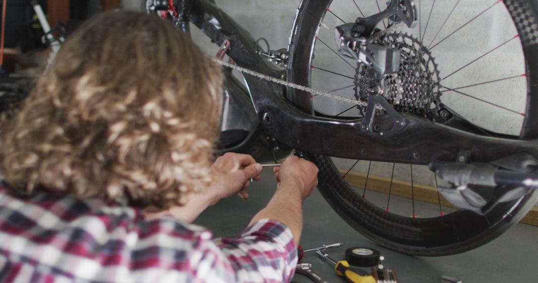 Mechanic repairing bicycle drivetrain in workshop - Free Images, Stock Photos and Pictures on Pikwizard.com