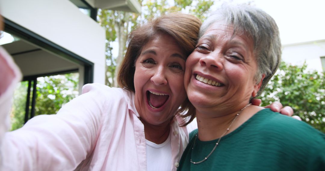 Joyful Mother and Daughter Taking Selfie in Backyard