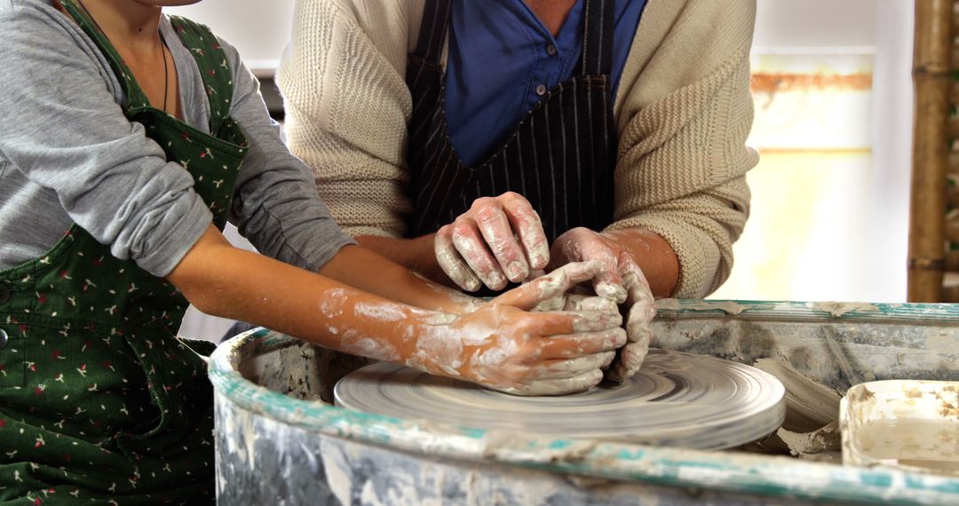 Instructor Guiding Student in Pottery Sculpting Session - Free Images, Stock Photos and Pictures on Pikwizard.com