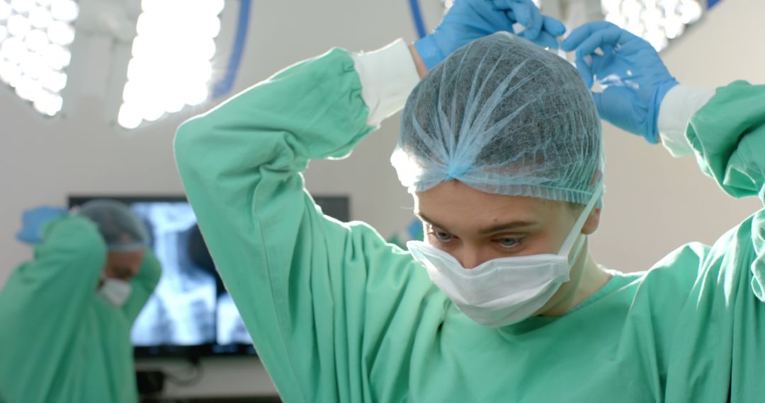 Surgeon Preparing for Operation by Adjusting Surgical Cap - Free Images, Stock Photos and Pictures on Pikwizard.com