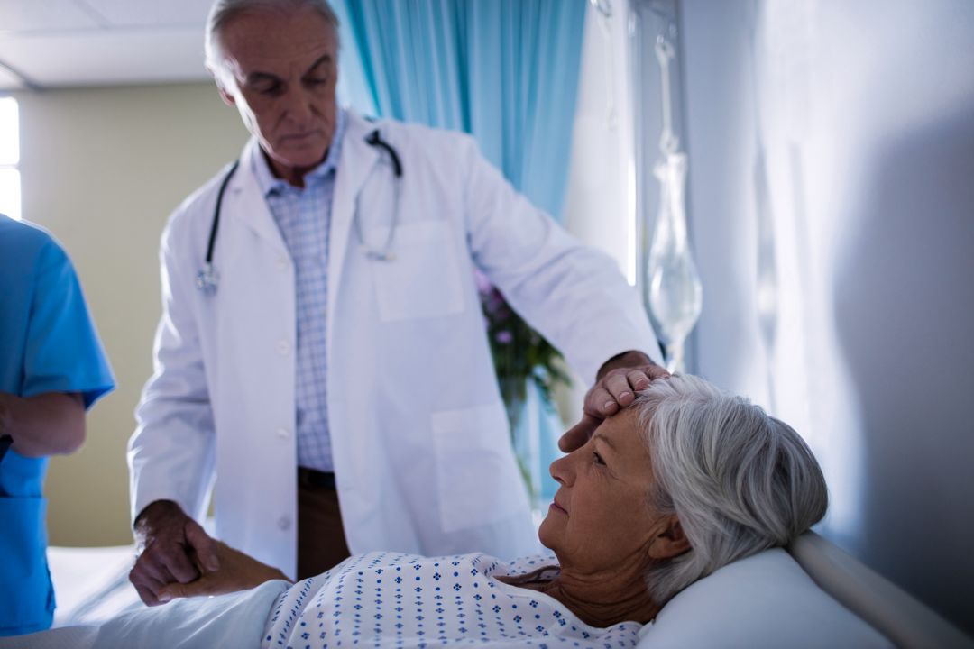 Doctors comforting senior patient on bed - Free Images, Stock Photos and Pictures on Pikwizard.com