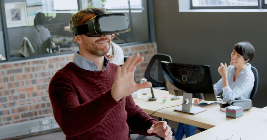 Happy professional using VR headset in modern office space - Free Images, Stock Photos and Pictures on Pikwizard.com