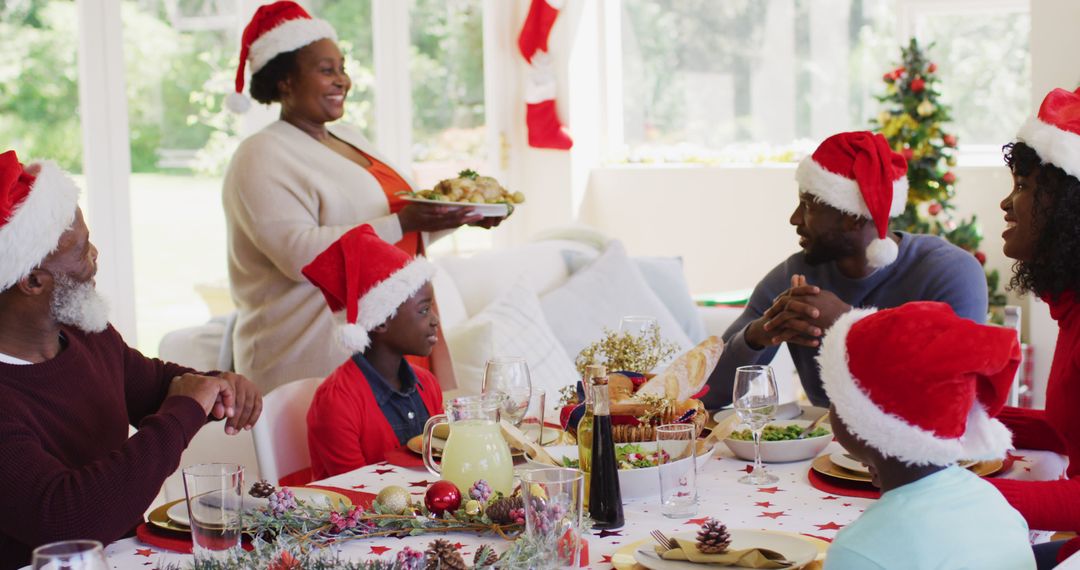 Happy African American Family Celebrating Christmas at Festive Dinner Table - Free Images, Stock Photos and Pictures on Pikwizard.com