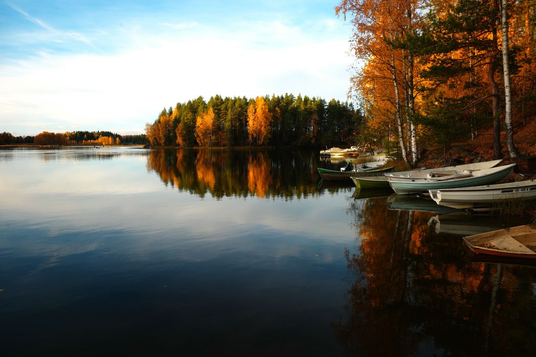 Peaceful Autumn Lake with Colorful Foliage and Rowboats - Free Images, Stock Photos and Pictures on Pikwizard.com