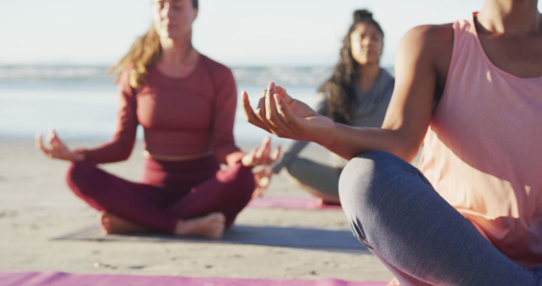 Group of diverse female friends meditating at the beach - Free Images, Stock Photos and Pictures on Pikwizard.com