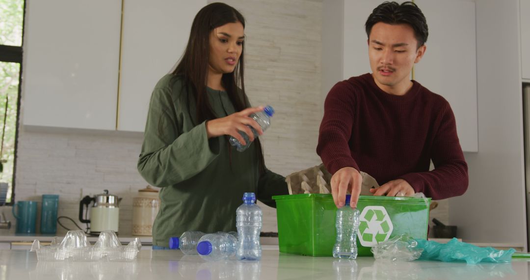 Image of diverse couple collecting bottles for recycling - Free Images, Stock Photos and Pictures on Pikwizard.com