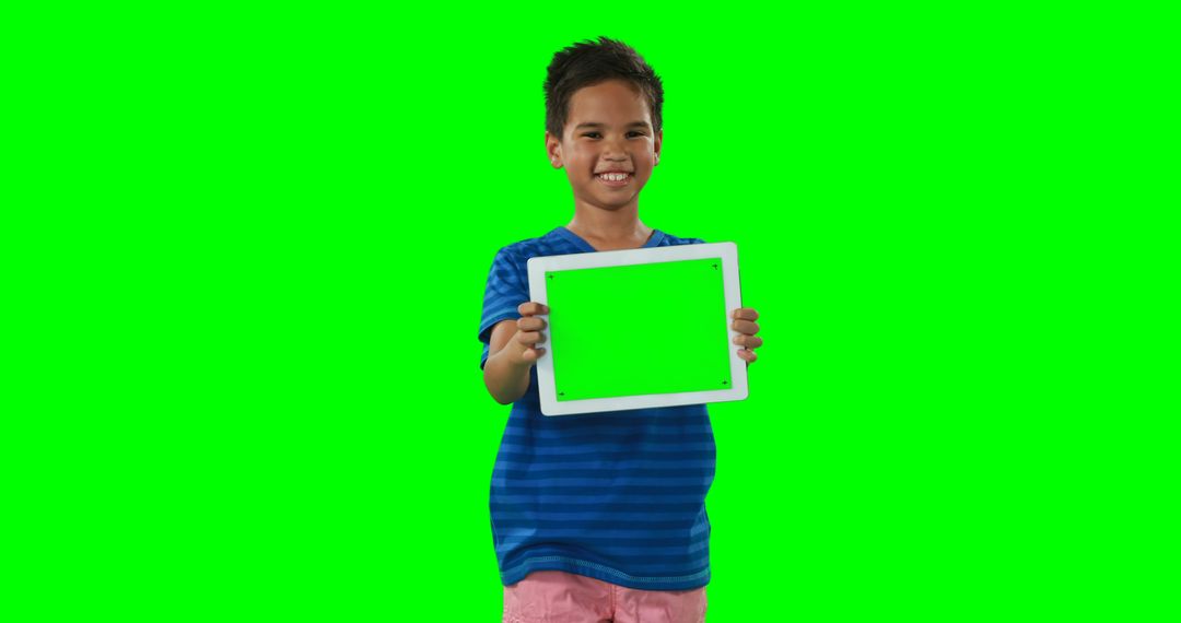 Smiling Boy Holding Tablet with Green Screen - Free Images, Stock Photos and Pictures on Pikwizard.com