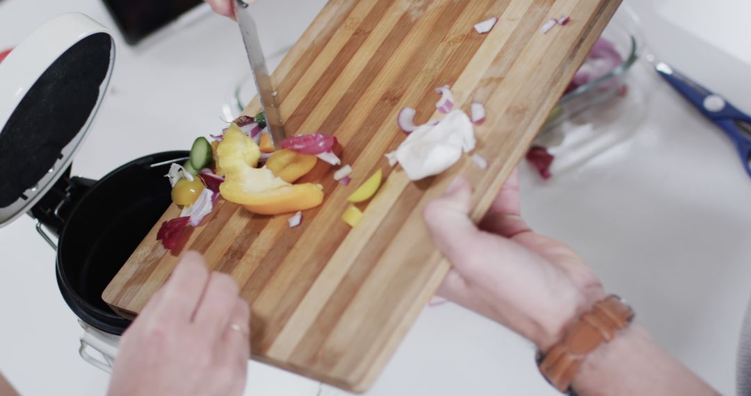 Couple Disposing Vegetable Peelings on Cutting Board - Free Images, Stock Photos and Pictures on Pikwizard.com