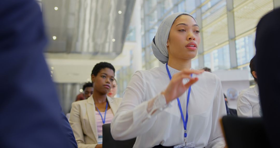 Diverse Business Seminar with Engaged Attendees Raising Questions