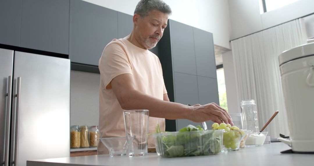 Middle-aged Man Preparing Healthy Breakfast in Modern Kitchen - Free Images, Stock Photos and Pictures on Pikwizard.com