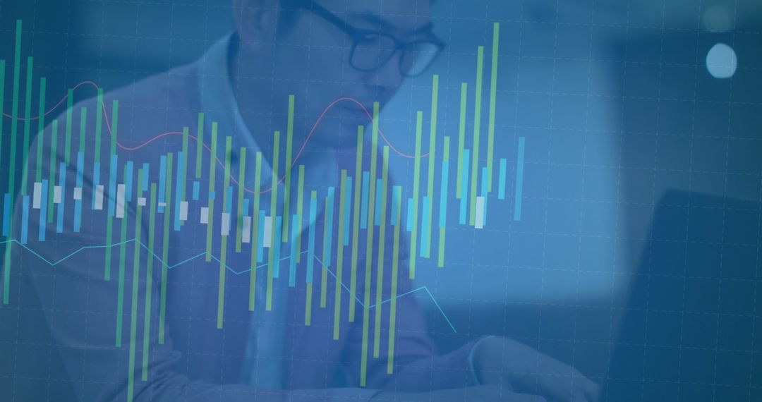 Financial Analyst Typing on Laptop with Overlaid Data Graphics