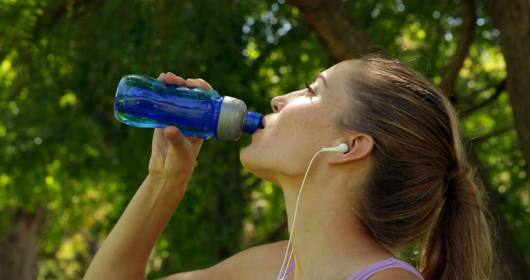 Woman Hydrating Outdoors with Water Bottle in Summer - Free Images, Stock Photos and Pictures on Pikwizard.com