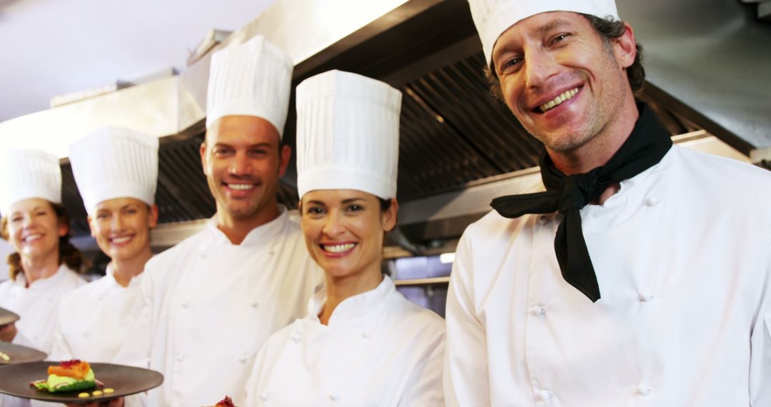 Smiling Chefs Posing in Restaurant Kitchen - Free Images, Stock Photos and Pictures on Pikwizard.com