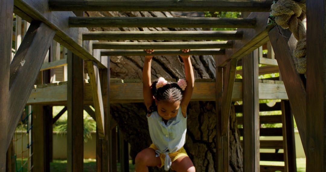 Young Girl Playing on Wooden Jungle Gym Outdoors - Free Images, Stock Photos and Pictures on Pikwizard.com