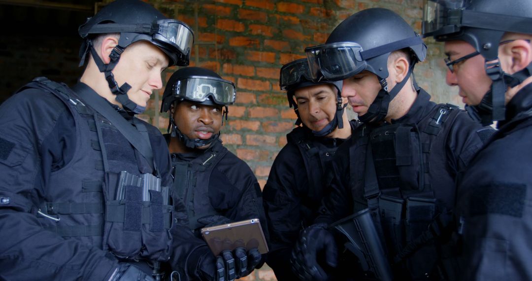 SWAT Team Members Planning and Consulting using Tablet - Free Images, Stock Photos and Pictures on Pikwizard.com