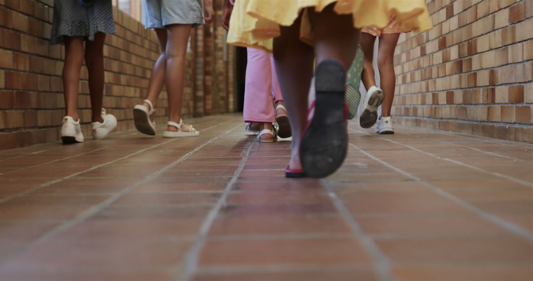 Children Walking Down School Corridor Back View