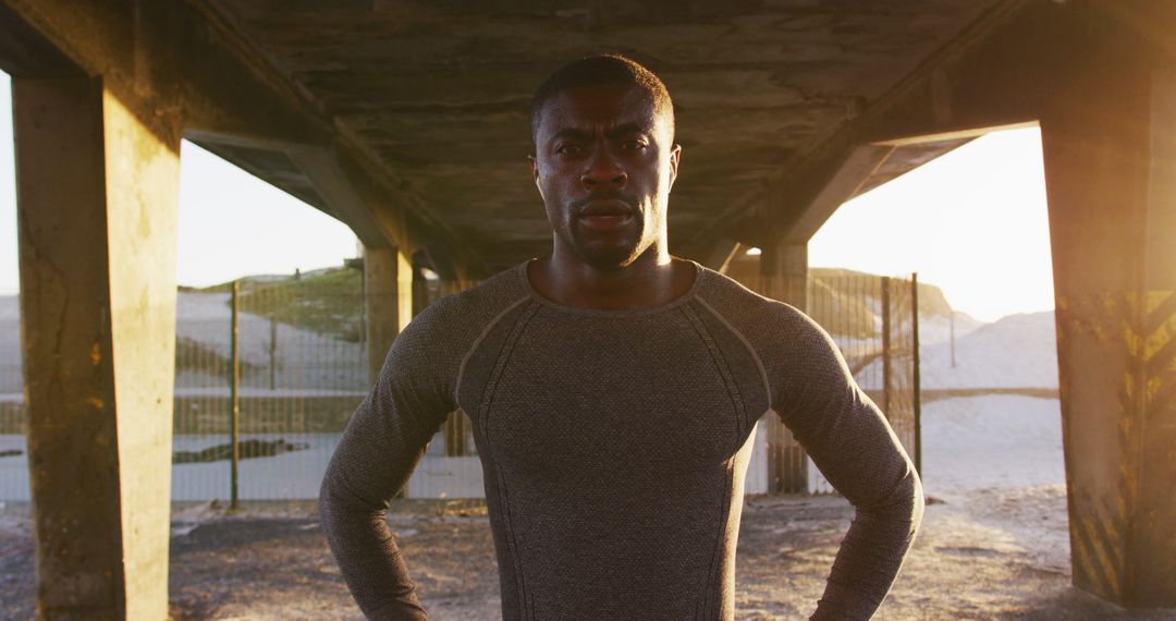 Determined Athlete Standing Under Bridge Structure at Sunrise - Free Images, Stock Photos and Pictures on Pikwizard.com