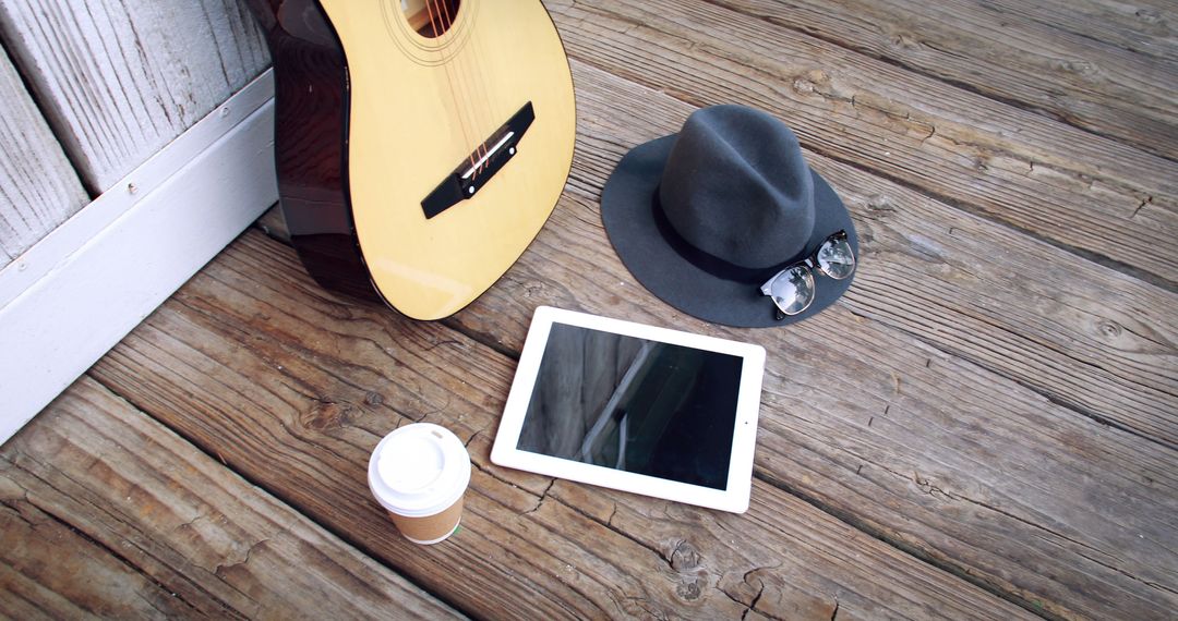 Annual flat lay with guitar tablet hat coffee outdoor wooden deck - Free Images, Stock Photos and Pictures on Pikwizard.com