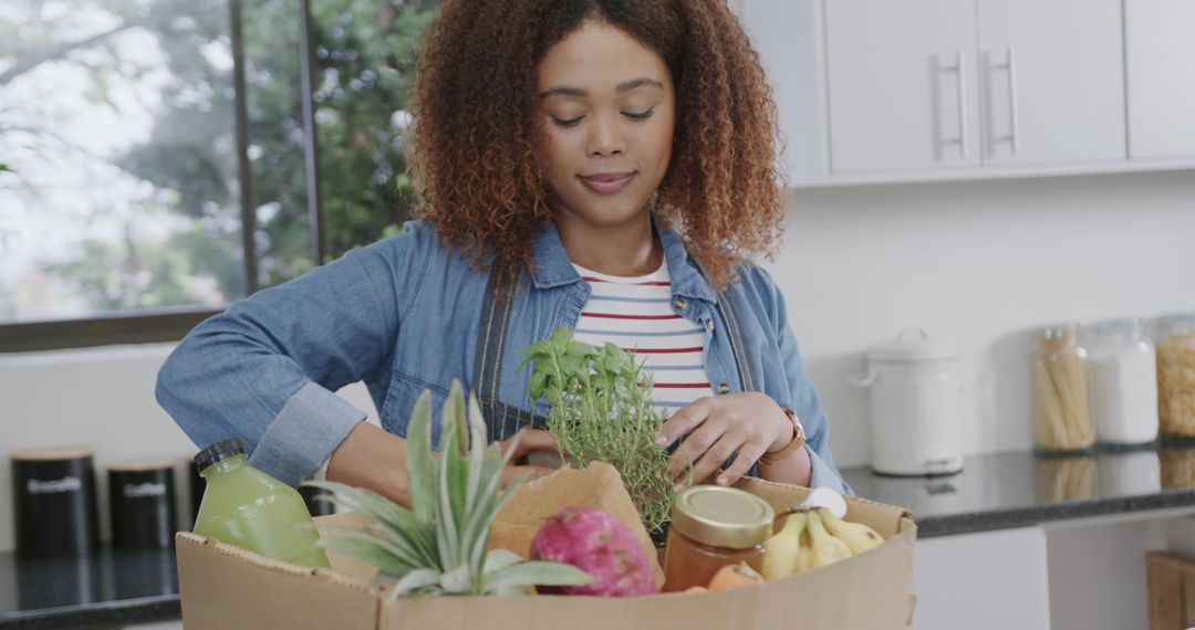 Woman Unpacking Organic Fruits and Vegetables in Modern Kitchen - Free Images, Stock Photos and Pictures on Pikwizard.com