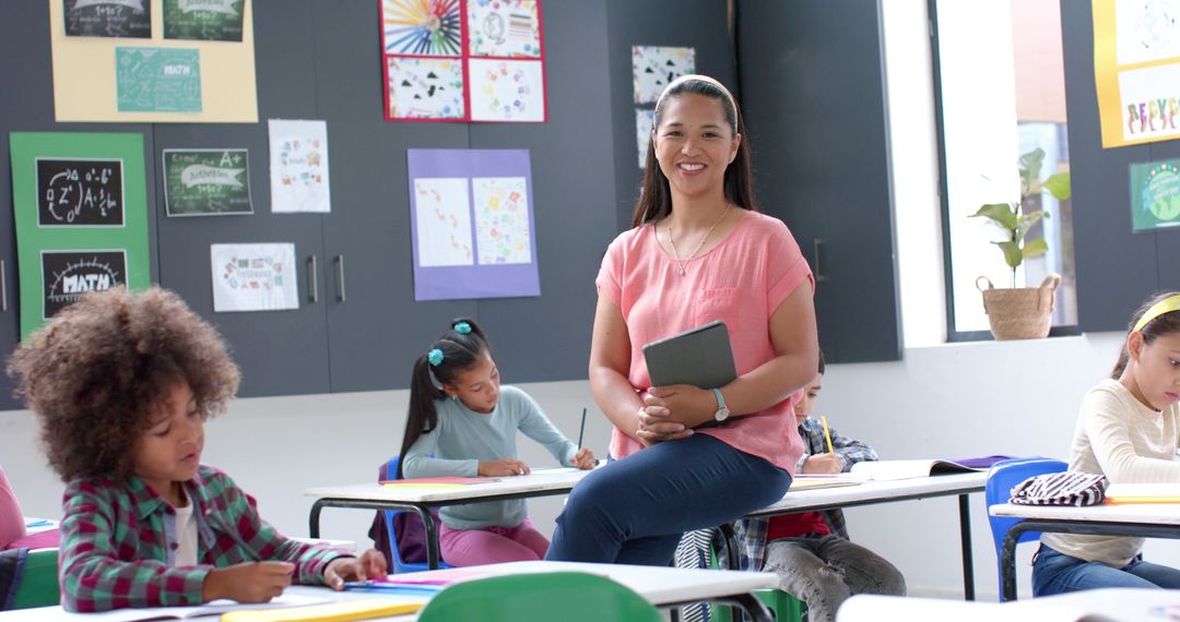 Teacher with Tablet Guiding Attentive Students in Cheerful Class