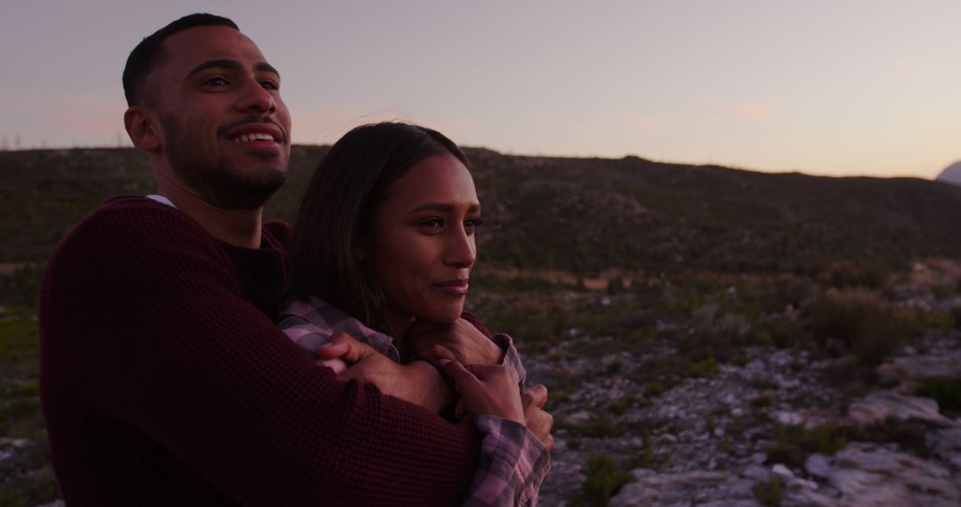Couple Embracing Quiet Sunset in Serene Nature Setting