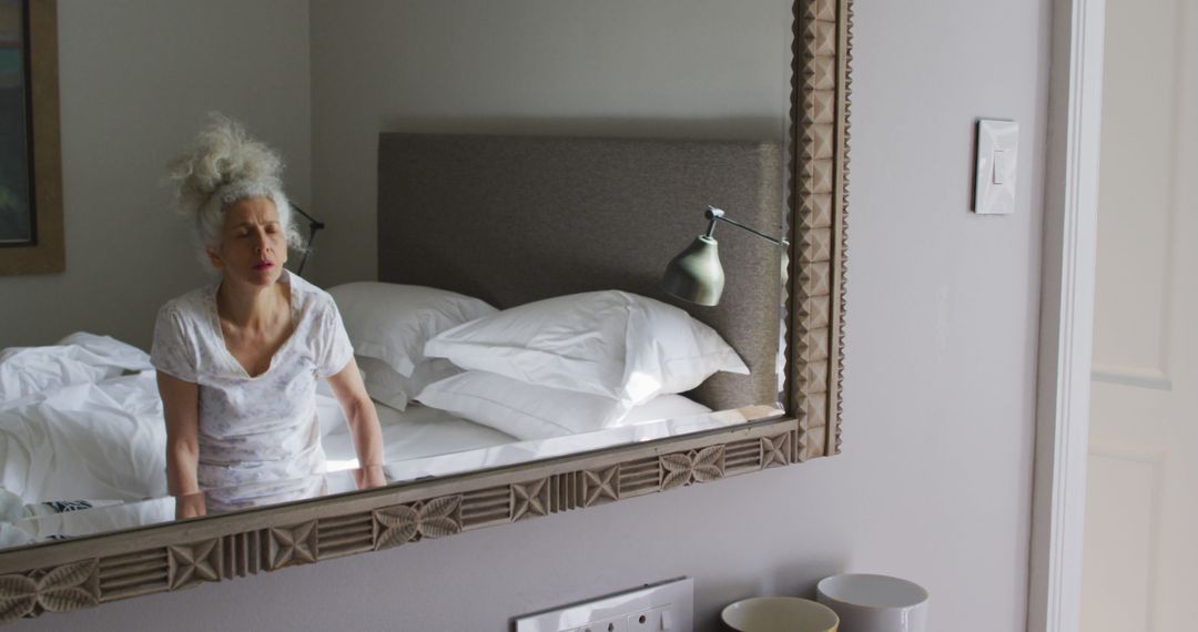 Woman Reflecting in Mirror in Comfortable Minimalist Bedroom - Free Images, Stock Photos and Pictures on Pikwizard.com