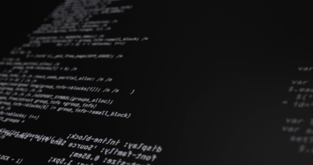 Lines of Code on Computer Screen in Dimly Lit Room