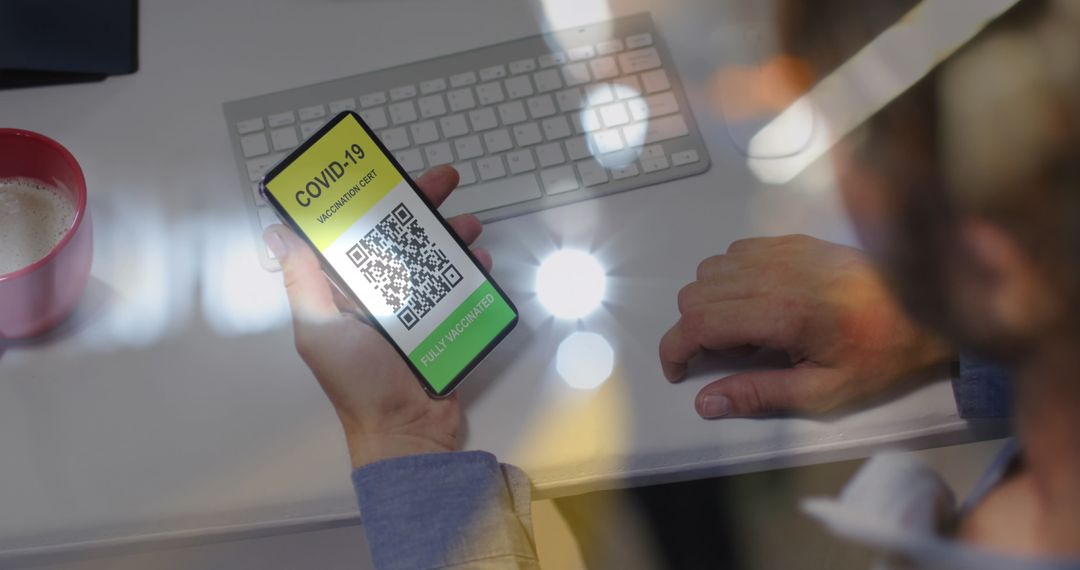 Person Holding Smartphone with COVID-19 Vaccination Passport QR Code